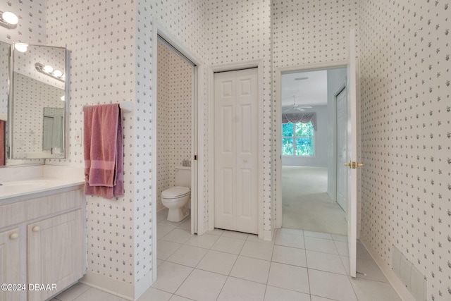 bathroom featuring toilet, vanity, and tile patterned flooring