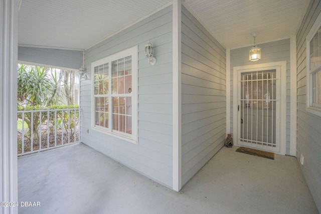 view of exterior entry with a porch