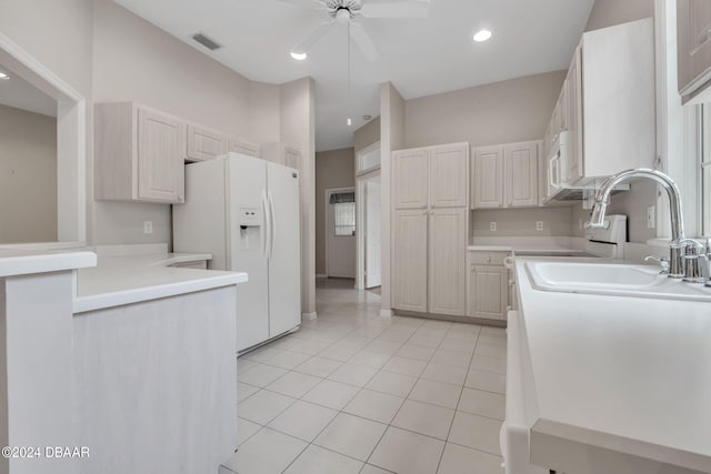 kitchen with light tile patterned flooring, sink, ceiling fan, white refrigerator with ice dispenser, and white cabinets