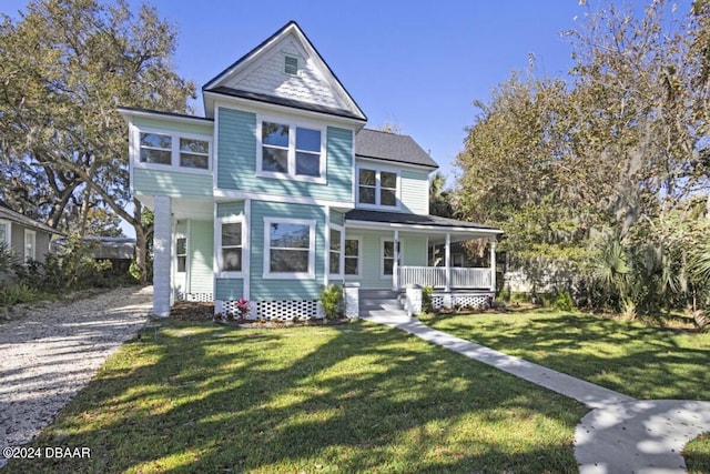 view of front of property featuring a front yard and covered porch