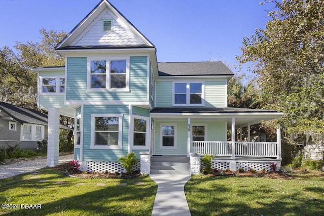 view of front of property with covered porch and a front yard