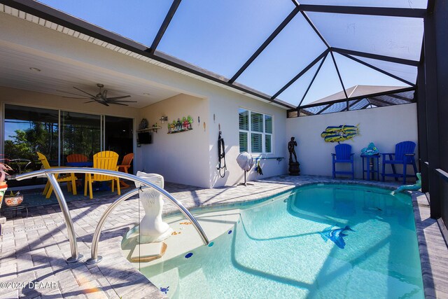 view of pool featuring a patio, ceiling fan, and a lanai