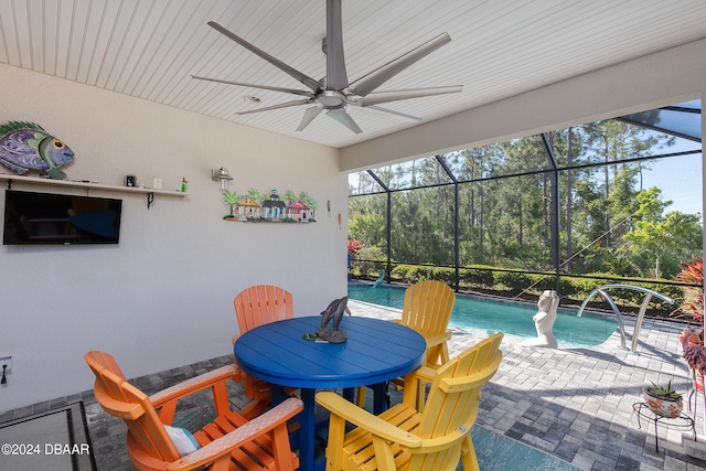 view of patio featuring glass enclosure and ceiling fan