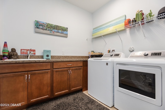 washroom with washer and clothes dryer and sink