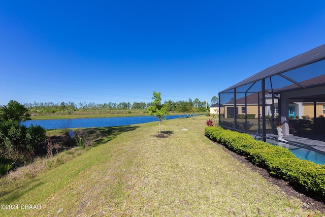 view of yard featuring a water view, glass enclosure, and a swimming pool