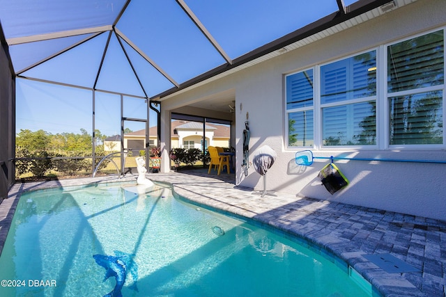 view of pool featuring a patio and glass enclosure