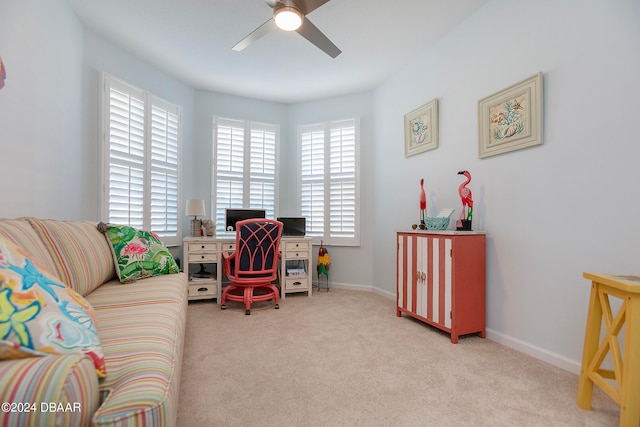 carpeted home office featuring ceiling fan