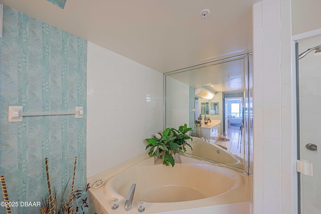 bathroom with plus walk in shower, vaulted ceiling, and tile walls