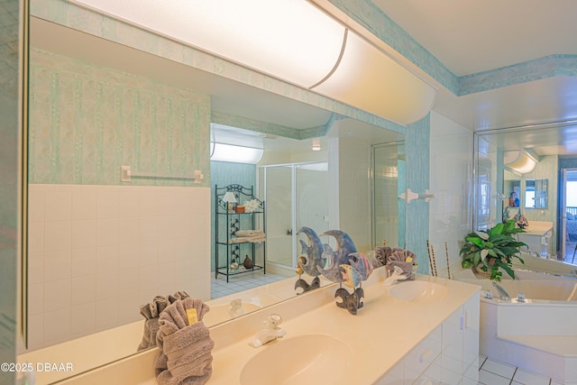 bathroom with vanity, separate shower and tub, and tile walls