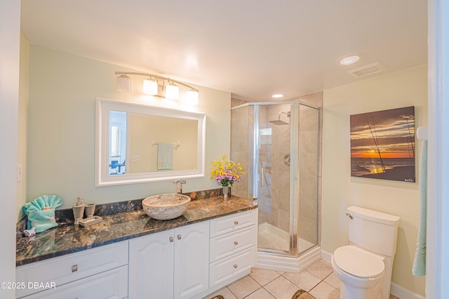 bathroom featuring vanity, tile patterned floors, toilet, and walk in shower