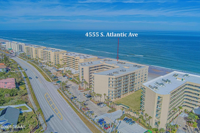 bird's eye view featuring a water view and a view of the beach