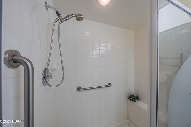 bathroom with a shower with door