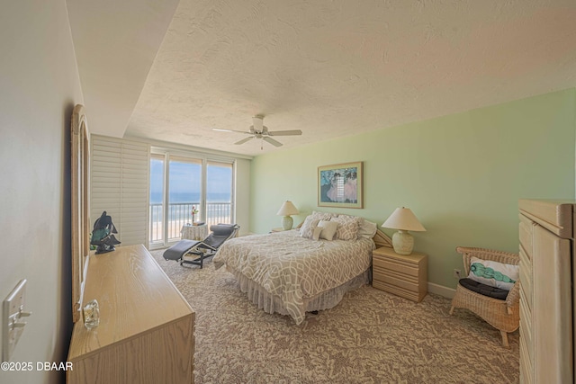 bedroom with ceiling fan, carpet floors, access to outside, and a textured ceiling