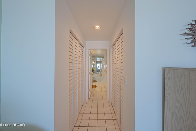 hallway featuring mail boxes and light tile patterned flooring