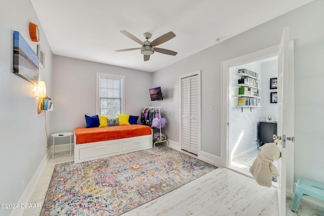 bedroom with ceiling fan and a closet