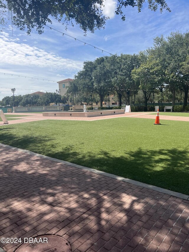 view of property's community with a lawn