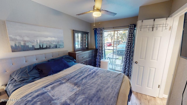 bedroom featuring access to exterior, ceiling fan, and light hardwood / wood-style floors