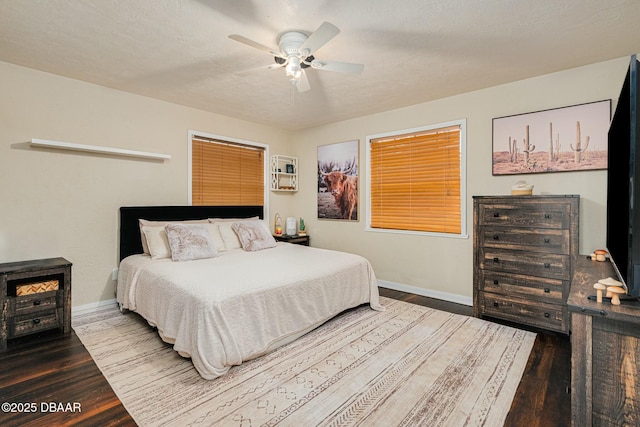 bedroom with hardwood / wood-style flooring, ceiling fan, and a textured ceiling