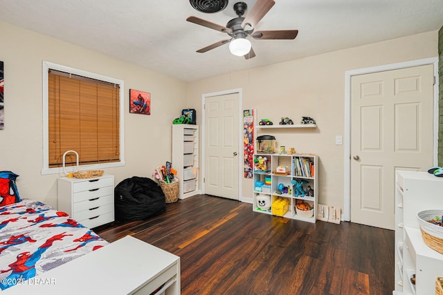 bedroom with dark hardwood / wood-style flooring and ceiling fan