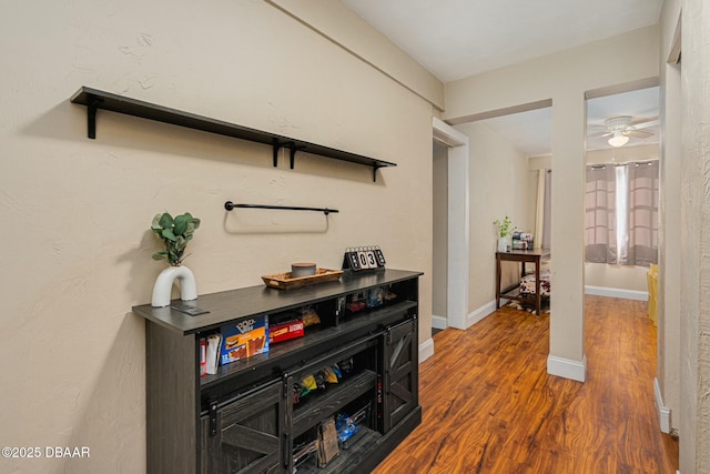 hallway with dark hardwood / wood-style flooring