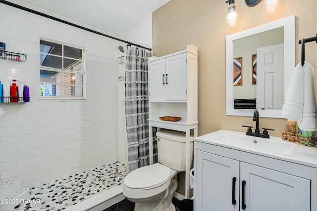 bathroom with a shower with shower curtain, vanity, and toilet