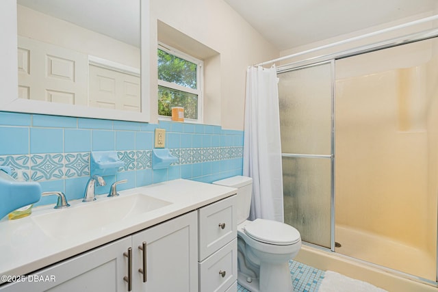 bathroom with toilet, vanity, tile walls, and a shower with shower curtain