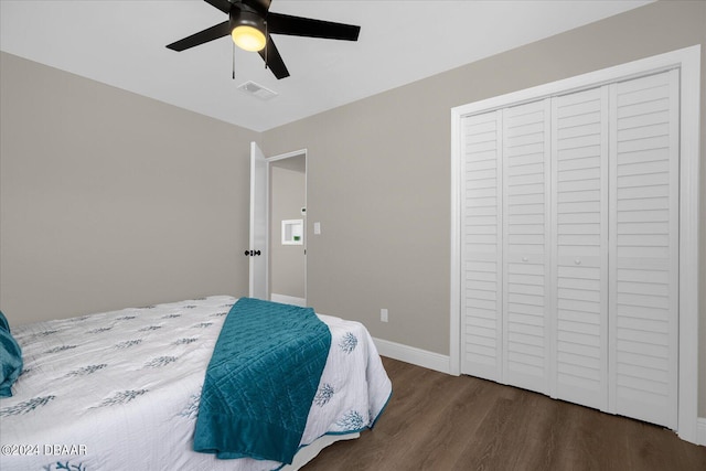 bedroom featuring ceiling fan, a closet, and dark hardwood / wood-style flooring