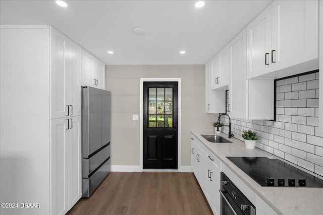 kitchen featuring white cabinetry, sink, black appliances, dark hardwood / wood-style floors, and decorative backsplash