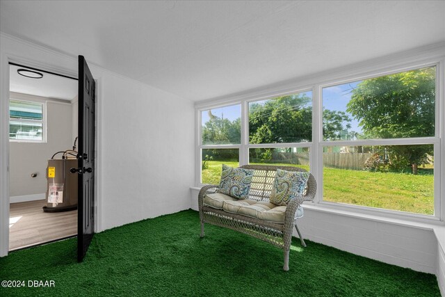 sunroom with water heater and a healthy amount of sunlight