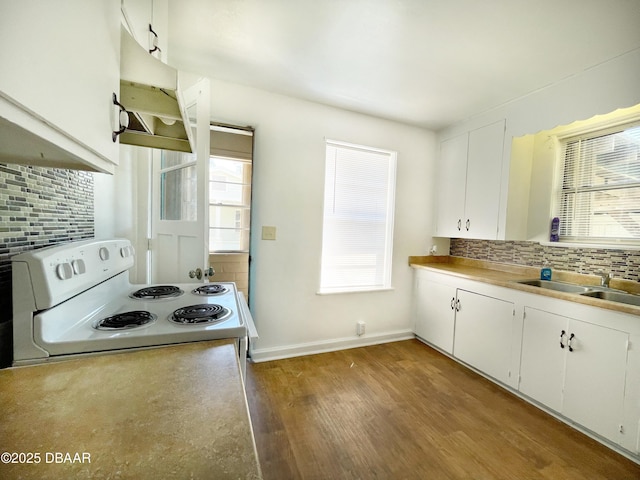 kitchen with white cabinetry, electric stove, backsplash, and a sink