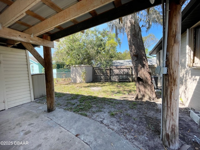 view of yard with a patio, a shed, a fenced backyard, and an outdoor structure