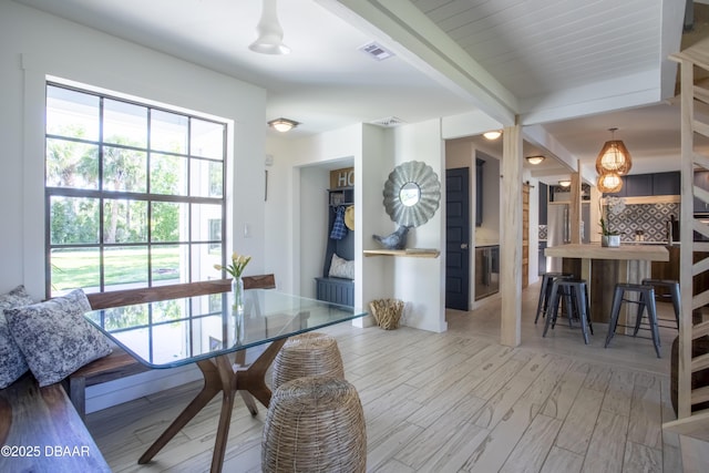 1076 Shockney Dr, Ormond Beach, FL 32174 - dining space featuring plenty of natural light, wood finished floors, and beam ceiling