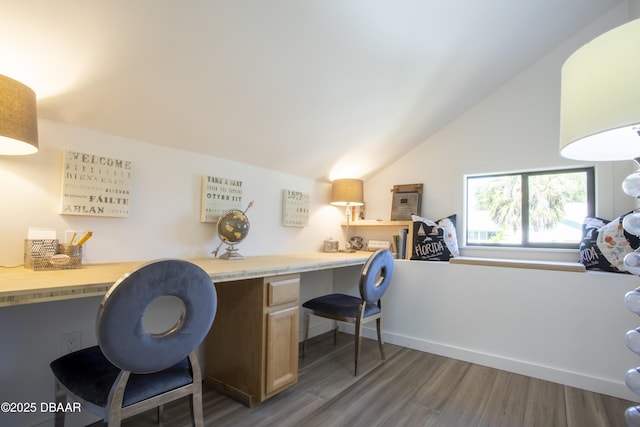 1076 Shockney Dr, Ormond Beach, FL 32174 - home office with built in study area, lofted ceiling, and wood finished floors