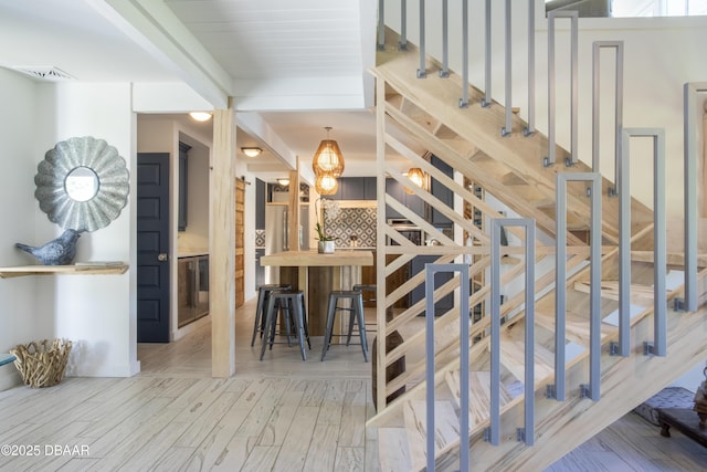 1076 Shockney Dr, Ormond Beach, FL 32174 - stairway with wood finished floors and beamed ceiling