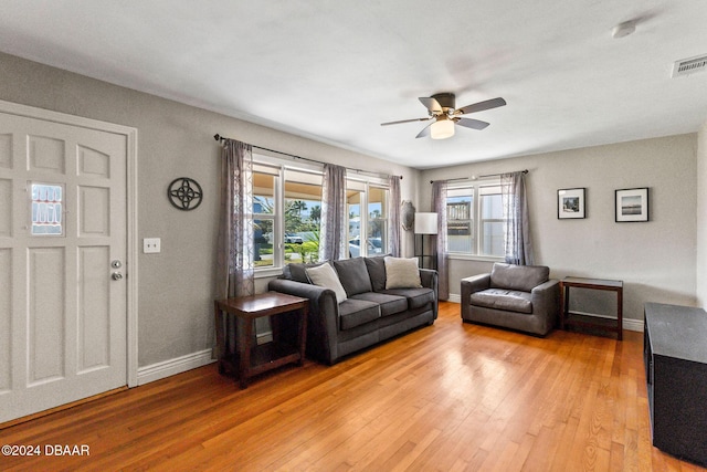 living room featuring ceiling fan and light wood-type flooring