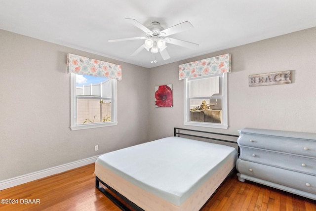 bedroom with ceiling fan and hardwood / wood-style floors