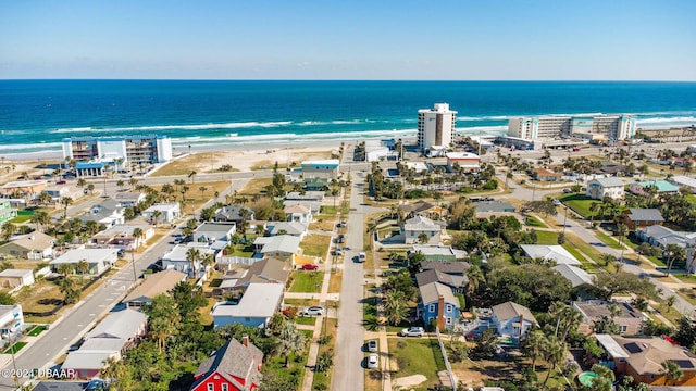 drone / aerial view with a water view and a beach view