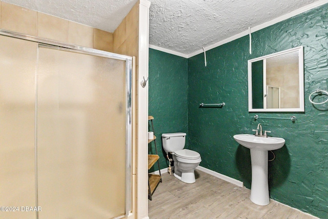 bathroom featuring walk in shower, ornamental molding, a textured ceiling, hardwood / wood-style floors, and toilet