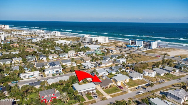 birds eye view of property featuring a water view and a view of the beach