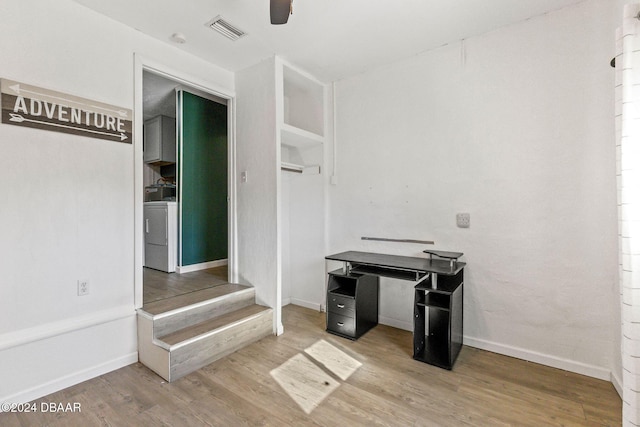 interior space featuring ceiling fan, washer / dryer, and wood-type flooring