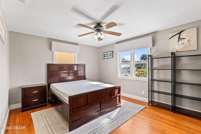 bedroom with light hardwood / wood-style floors and ceiling fan