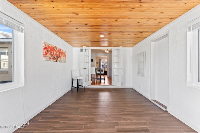 spare room with dark hardwood / wood-style flooring, wooden ceiling, and french doors