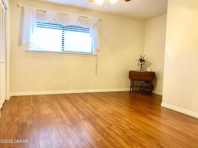 146 Deer Lake Cir, Ormond Beach, FL 32174 - empty room featuring wood finished floors, healthy amount of natural light, a ceiling fan, and baseboards