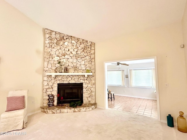 146 Deer Lake Cir, Ormond Beach, FL 32174 - unfurnished living room with carpet, a stone fireplace, tile patterned floors, lofted ceiling, and a ceiling fan