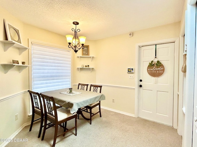 146 Deer Lake Cir, Ormond Beach, FL 32174 - dining space with light carpet, a textured ceiling, and a chandelier