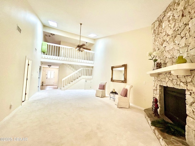 146 Deer Lake Cir, Ormond Beach, FL 32174 - sitting room with carpet flooring, a fireplace, stairway, and a towering ceiling