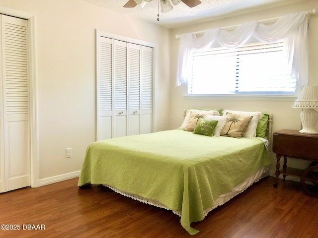 146 Deer Lake Cir, Ormond Beach, FL 32174 - bedroom with dark wood-style floors, two closets, baseboards, and ceiling fan