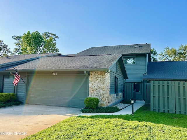 146 Deer Lake Cir, Ormond Beach, FL 32174 - view of front of house featuring stone siding, a shingled roof, an attached garage, driveway, and a front yard