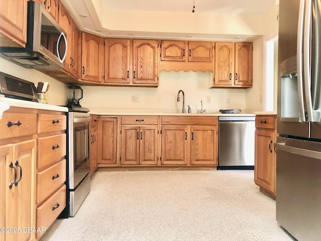 146 Deer Lake Cir, Ormond Beach, FL 32174 - kitchen with stainless steel appliances, light carpet, and brown cabinetry