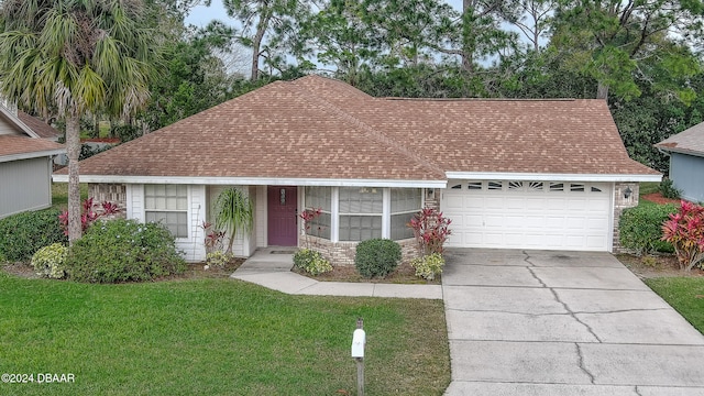 view of front of home featuring a garage and a front yard